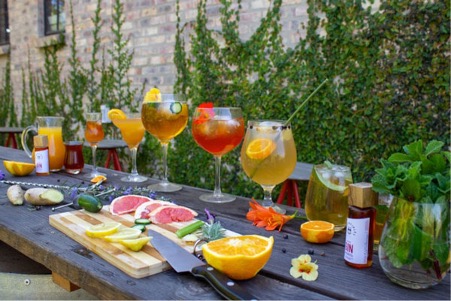 A feast of different cocktails and garnishes displayed on the 1st Principles table.