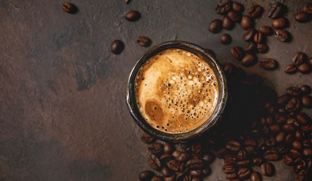 Espresso mug with coffee beans